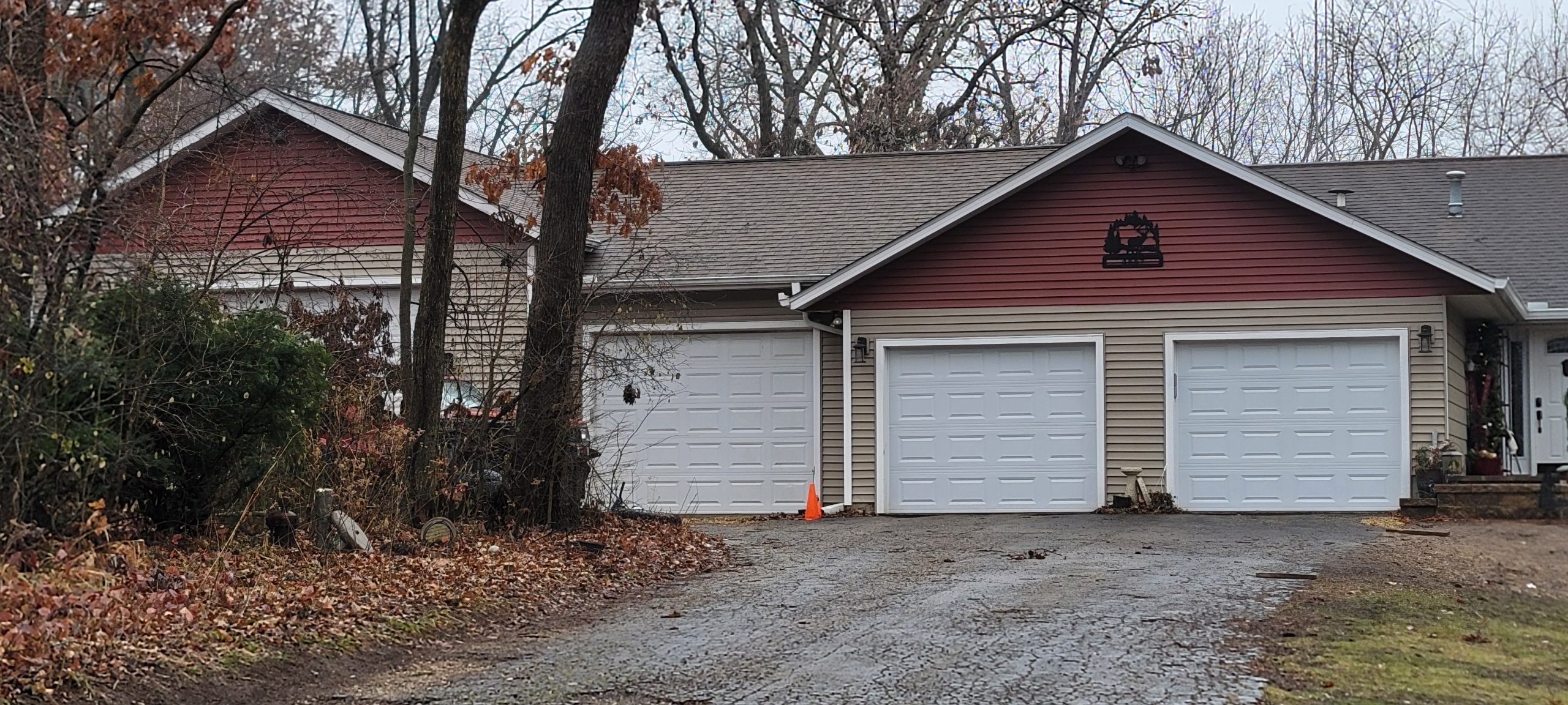 Suburban house with attached three-car garage and autumn trees