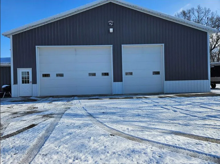 Two farm garage doors, one wider than the other.